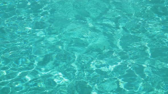 Pure blue water in pool with light reflections