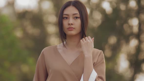 Asian Woman in Traditional Japanese Kimono Outdoors