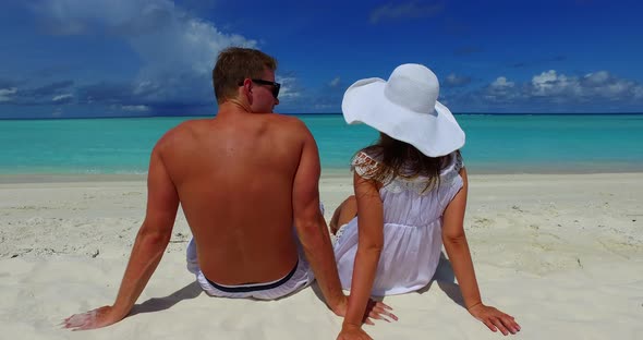 Romantic people on honeymoon vacation enjoy luxury on beach on clean white sand 4K background