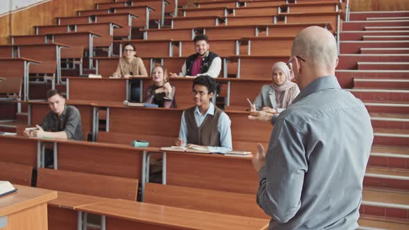 Male Professor Giving Lecture to Students