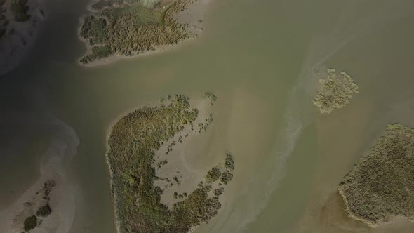 Topdown Of Marshes With Islets On A River During Low Tide In Portugal. Aerial Ascending