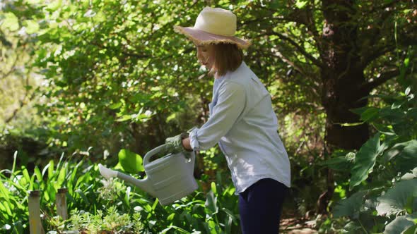 Asian woman gardening and smiling on sunny day