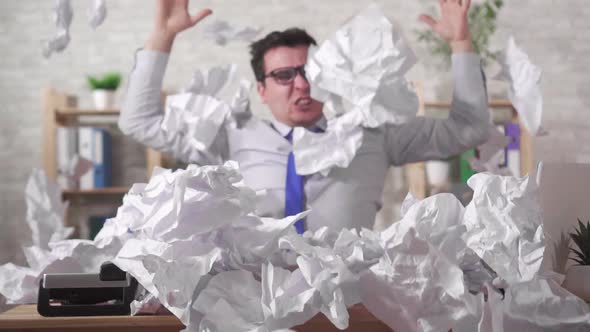 Screaming Expressive Man Office Worker in a Heaps of Office Papers on the Table Slow Mo