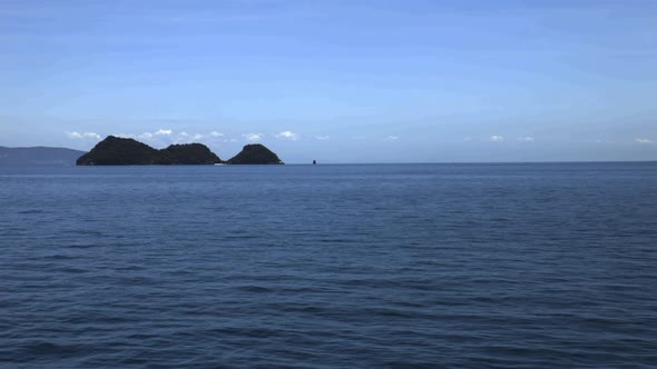 Looking at the sea, island and sky from the sea. (Slow motion - Angle 018)