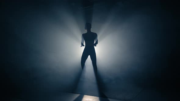 Fit Woman Training. Backlighted Woman Silhouette Doing High Knee Exercises. Slow Motion.