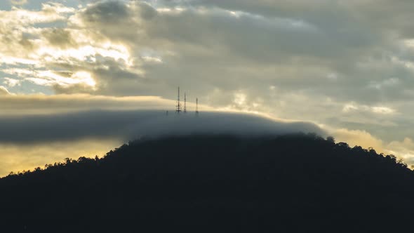 Timelapse communication tower flooded with moving cloud