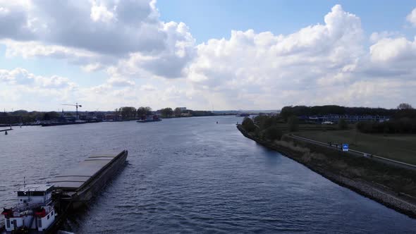 Container Vessel Of Crigee Sails Through Oude Maas River In Puttershoek In South Holland. wide shot