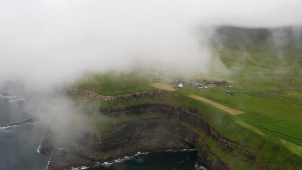 Sunset View of Mulafossur Waterfall and Gasadalur Village