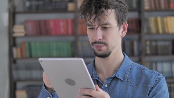 Excited Casual Young Man Winning Online on Tablet