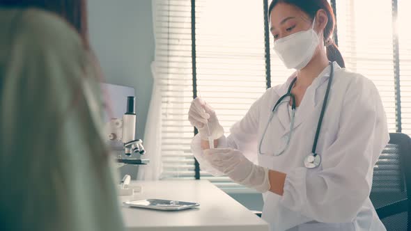 Close up of Asian specialist doctor doing quick swab for patient during Covid19 pandemic in hospital