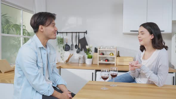 Asian young new marriage couple spend time together in kitchen at home.