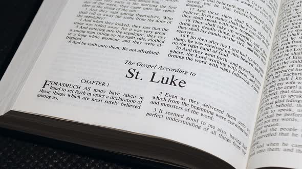 Close Up Shot of  Bible Page Turning to the book of Luke