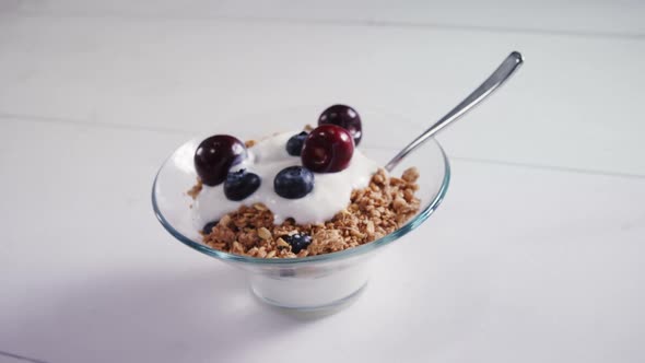 Bowl of yogurt muesli, cherries and blueberries for breakfast 4k