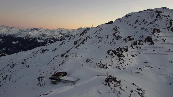 Snowy Mountain Skilifts and Furniculars and Skislopes in Austrian Alps Drone Flyover the Mountains