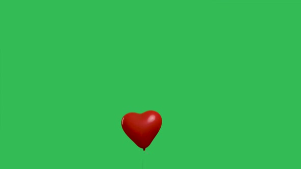 Red Balloon in the Shape of a Heart Flies Up and Flies Away Against the Background of a Green Screen