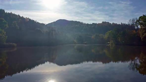 Aerial Above Lake with Autumn Foliage and Tree Reflections in Styria Thal Austria