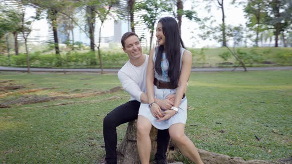 Multiracial Couple Having Fun at Park Laugh and Make Jokes Together