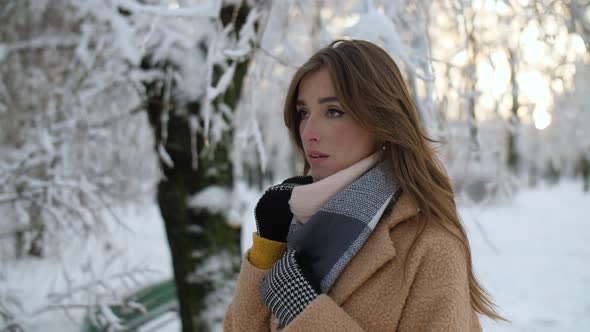 Girl in Snowy Tree Branches