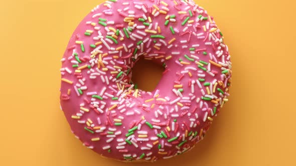 Multicolored Donut with Pink Glaze and Pastry Topping Isolated
