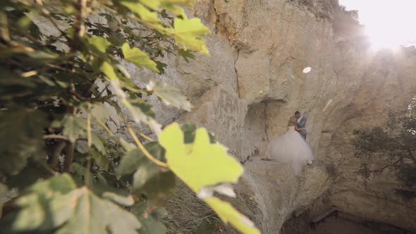 Wedding Couple Standing Together on a Mountainside. Newlyweds. Groom and Bride