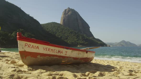 Slow motion of a fishing skiff on Red Beach in Rio.