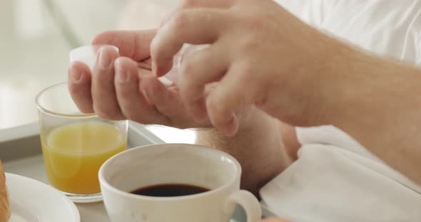 Close Up View of Man Dropping Pills From Tablet Bottle on Palm Hand and Taking One To Mouth. Man