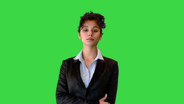 Young African American Businesswoman Looking Into the Camera on a Green Screen Chroma Key