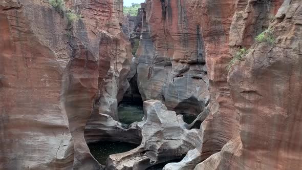 HD aerial drone footage of Bourke's Luck Potholes. Beautiful natural rock formations hewn by centuri