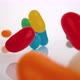 Camera follows jelly beans falling on surface. Slow Motion. - VideoHive Item for Sale