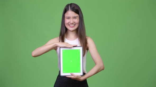 Young Beautiful Asian Businesswoman Showing Digital Tablet