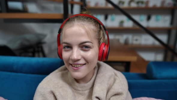 Closeup Joyful Teenage Girl Enjoying Music in Headphones Looking at Camera Singing Smiling