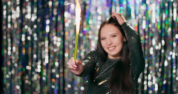 Cheerful Woman Holding Sparklers at the Party Teenage Girl Enjoying New Years Eve with Fireworks