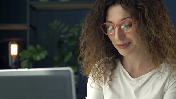 Portrait of a Middleaged Woman Working at a Laptop