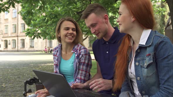 Students Work on Laptop on Campus