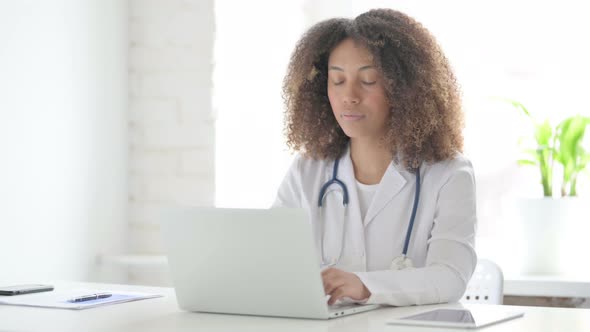 Afrcian Doctor Working on Laptop in Clinic