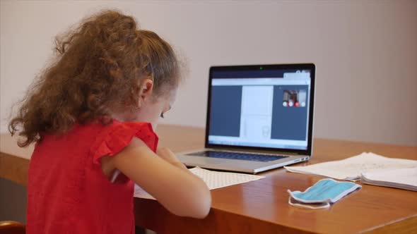Distance Learning Online Education Schoolgirl Sits at Home at Her Desk Performs a School Assignment