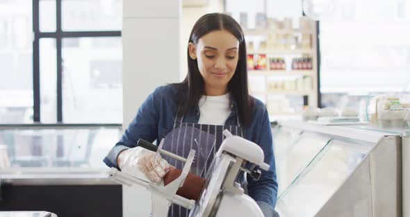 Animation of happy biracial waitress using meat cutting machine