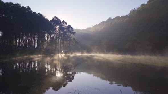 Fog or mist on river lake with forest trees in Pang Ung reservoir, Mae Hong Son, Thailand