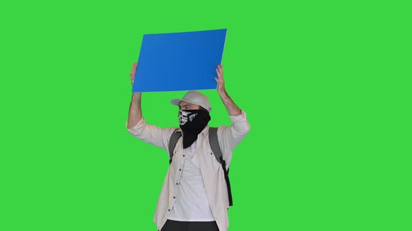 Radical Protesting Person with Sign in His Hands on a Green Screen Chroma Key