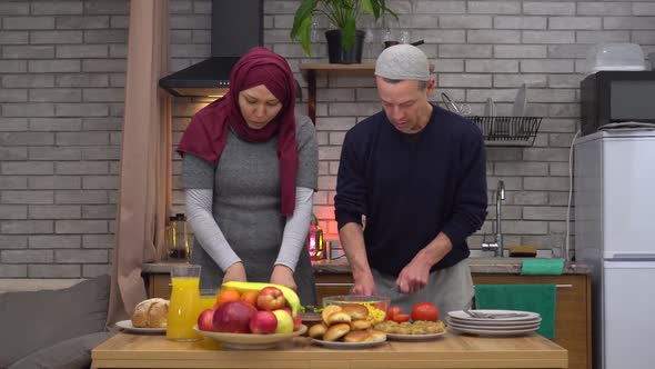 Happy Muslim Husband and Wife Cook Dinner Together in the Kitchen