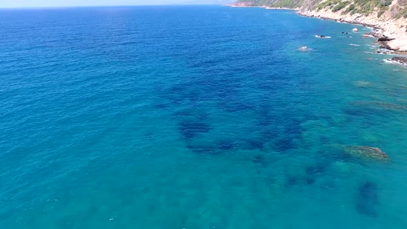 Aerial Clear Reef and Rocky Untouched Coastline of Bright Turquoise Sea