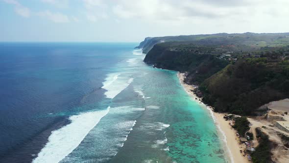 Tropical fly over clean view of a white paradise beach and aqua blue ocean background in colorful 4K