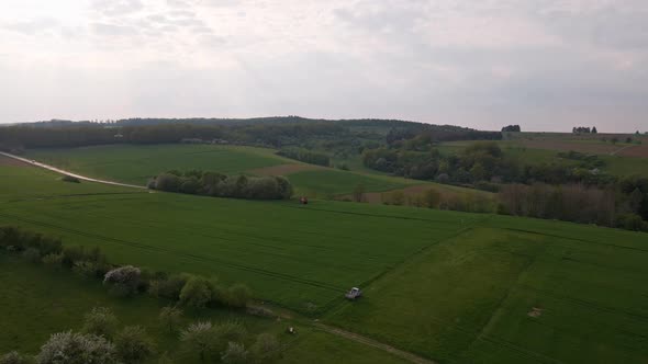 wide aerial view over vast green meadows between hills and forests of the german town of wetzlar in