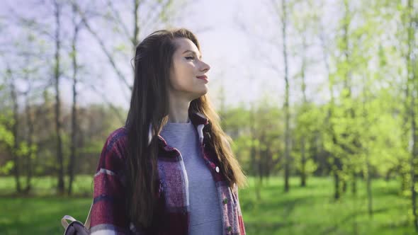 A Beautiful Young Brunette Got Out for a Walk in Nature