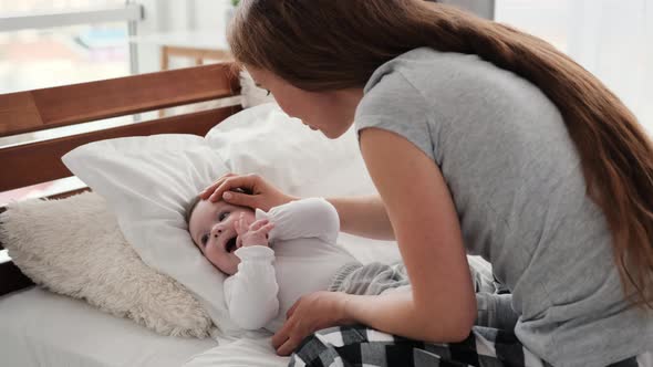 Mother with Child in the Bed