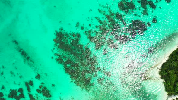 Tropical aerial abstract shot of a summer white paradise sand beach and turquoise sea background in 