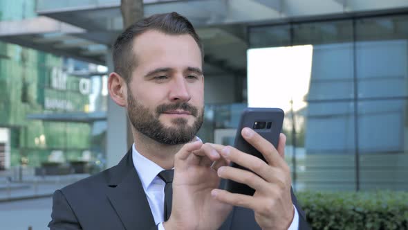 Beard Businessman Using Smartphone for Browsing online