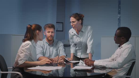 Young Businesswoman Presenting New Idea to Colleagues at Corporate Meeting