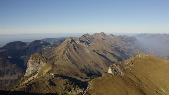 Overflying mountain cliff and revealing landscape belowRochers de Naye area, Prealps - Switzerland