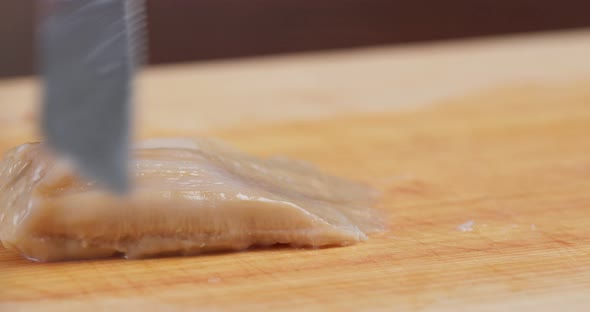 Cutting Fresh Geoduck on wooden board